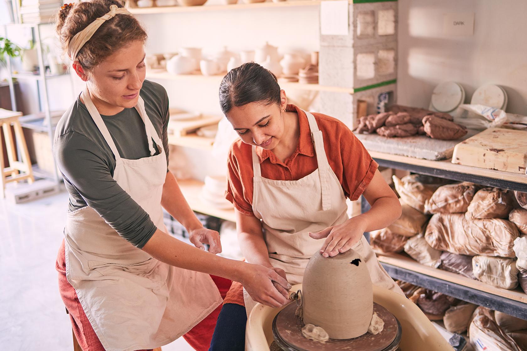 Pottery class in Wellington with adults shaping clay in a creative studio environment