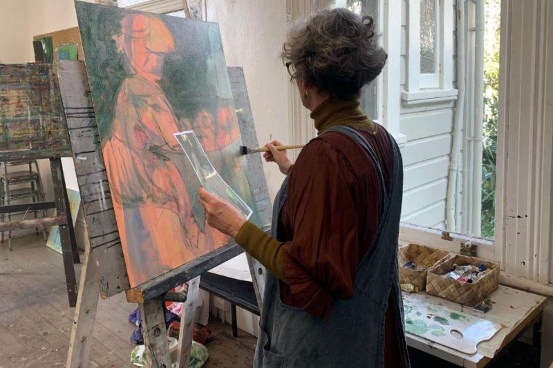 Adult art class at Inverlochy Art School in Wellington, with a student painting in the historic studio