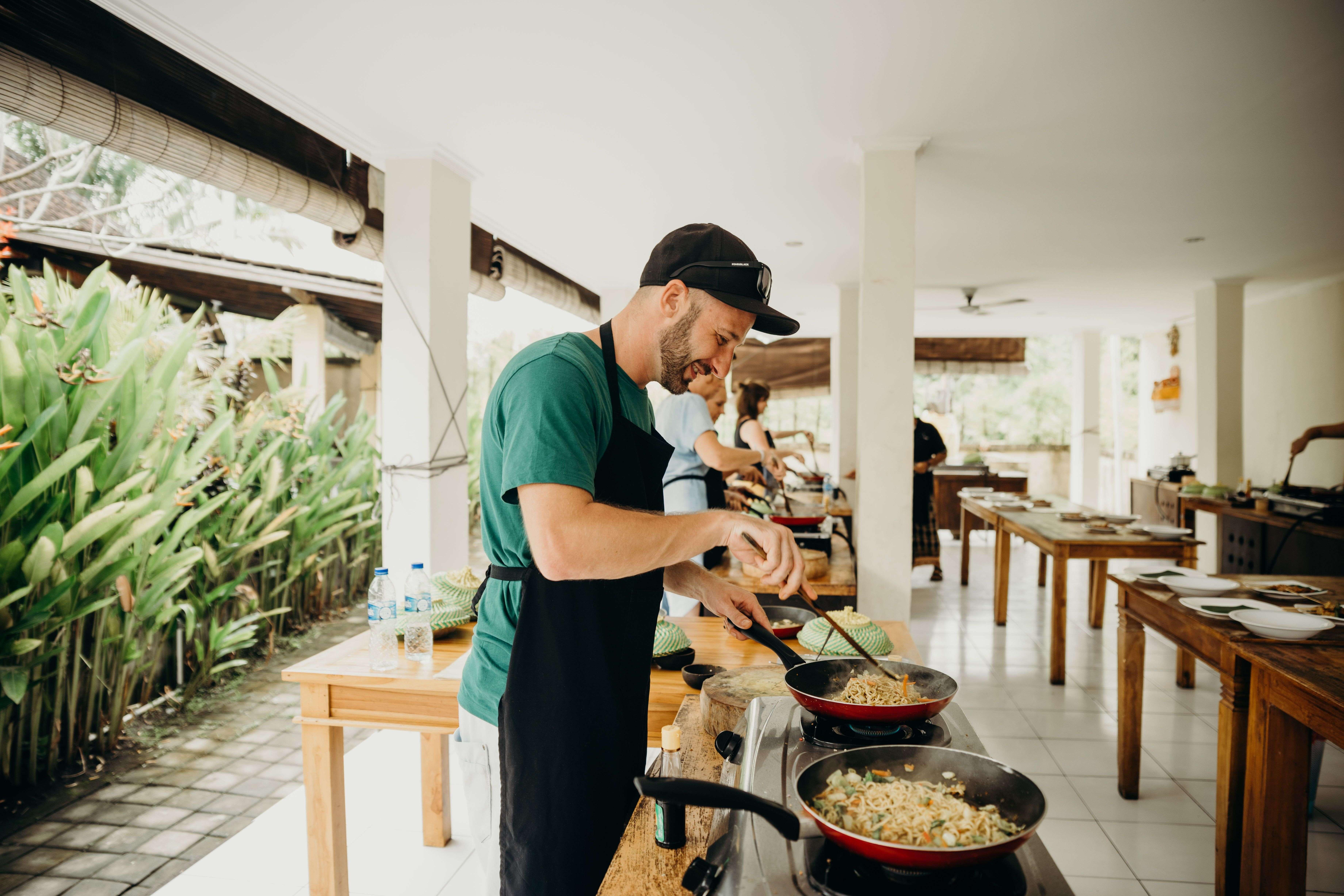 Man taking part in a cooking class, a hands-on Father’s Day experience in Christchurch