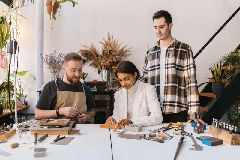 Adults taking part in a hands-on jewellery-making class.